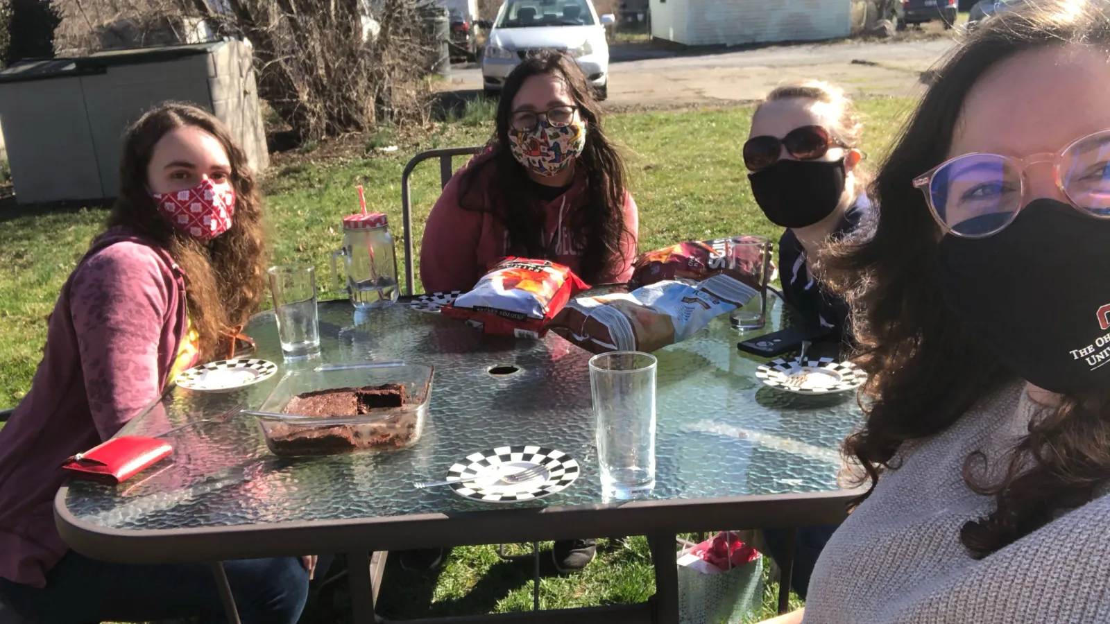 Members of an undergraduate mentoring group meeting masked and outdoors
