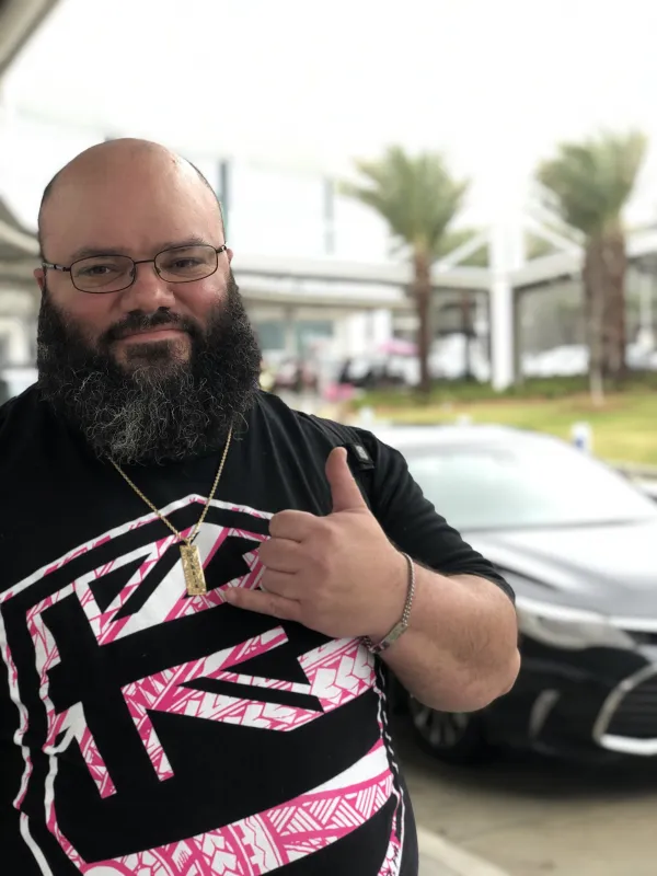 Clint Awai-Jennings wearing black shirt with a pink Hawaiian flag on it